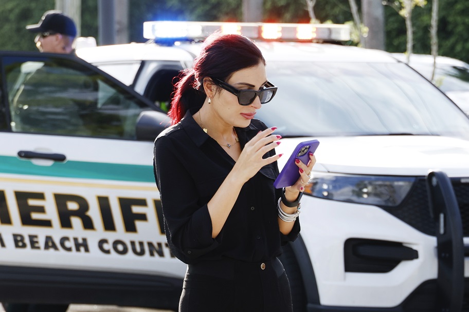 Laura Loomer looks at her phone.