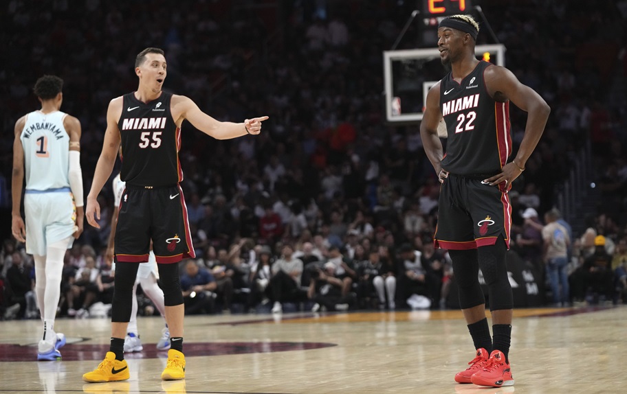 Jimmy Butler and Duncan Robinson talk during a Miami Heat game.